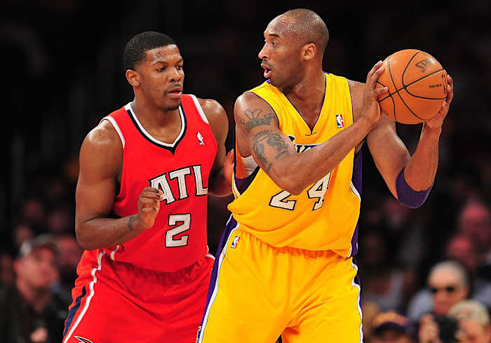 February 14, 2012; Los Angeles, CA, USA; Los Angeles Lakers shooting guard Kobe Bryant (24) controls the ball against the defense of Atlanta Hawks shooting guard Joe Johnson (2) during the first half at Staples Center.